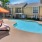 a pool with a table and chairs by it