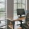 a desk with a computer and chairs