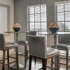 a room with a table chairs and a window