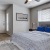 a bedroom with a bed and a fan