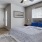 a bedroom with a bed and a fan