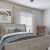 a bedroom with a bed and a chair