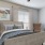 a bedroom with a bed and a chair