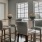 a room with a table chairs and a window